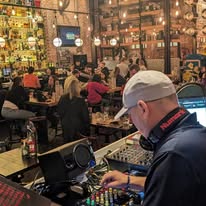 DJ Terry Bevvan performing in a busy venue